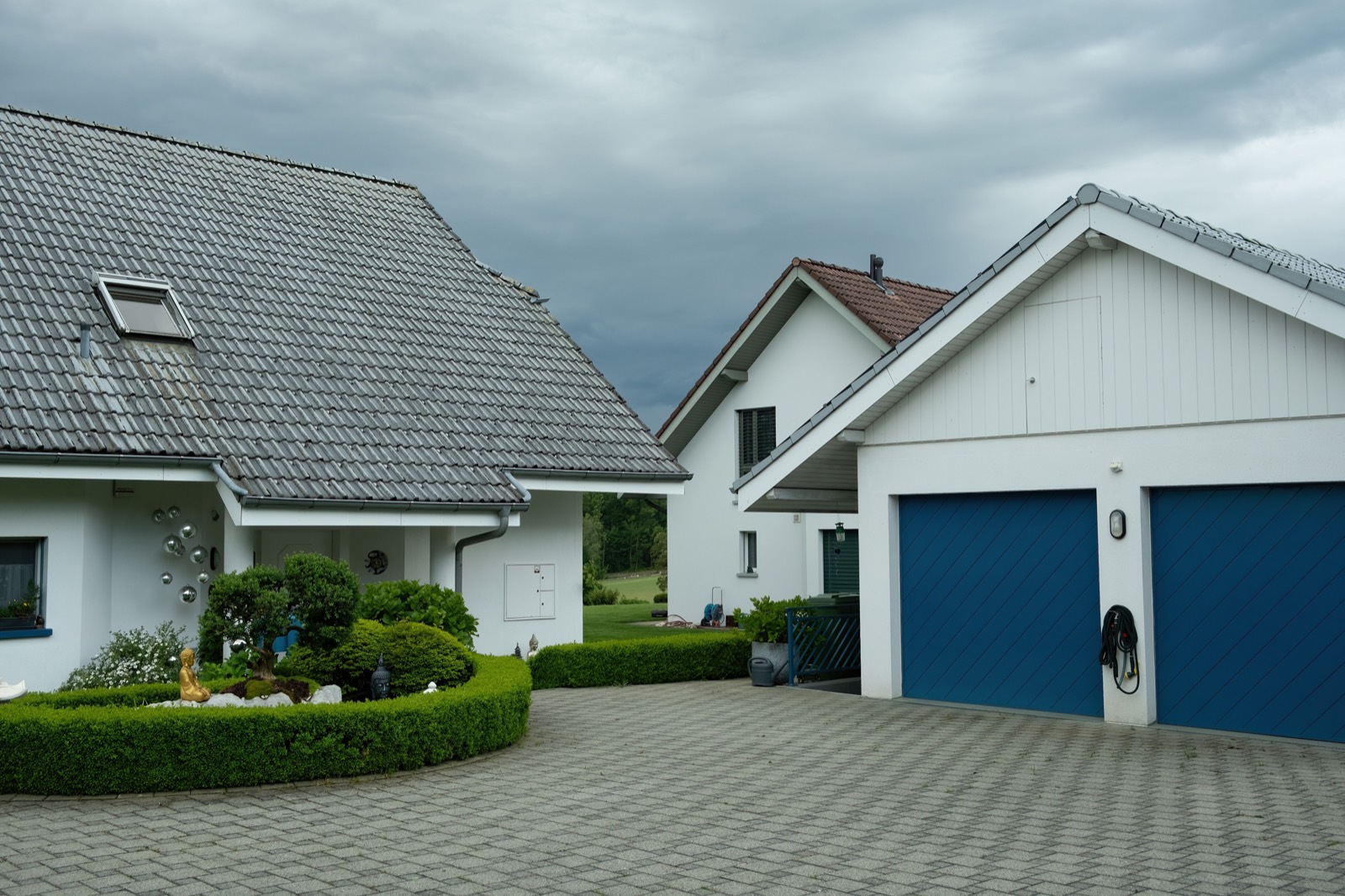 Finished residential concrete driveway leading to a home garage